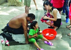 記者找到小女孩時(shí)，男子正帶著她在中央路上乞討 記者 施向輝/攝