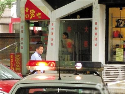 闖入面館的持刀男子與趕來的民警隔著玻璃門對峙，后店內(nèi)一名女童被其劫持。網(wǎng)友供圖