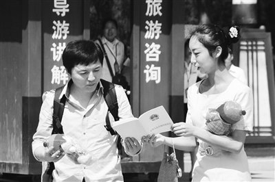 9月13日，西安臨潼華清池景區(qū)服務(wù)人員向游客介紹《旅游法》。