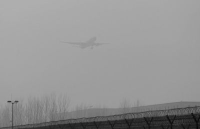 在首都機場，飛機在霧霾中降落。