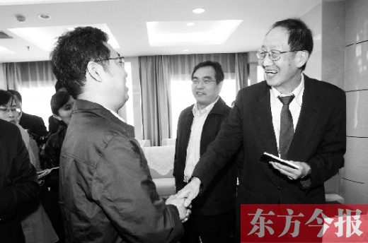 崔琦先生握手東方今報記者靳暉，感謝他把照片珍藏了15年