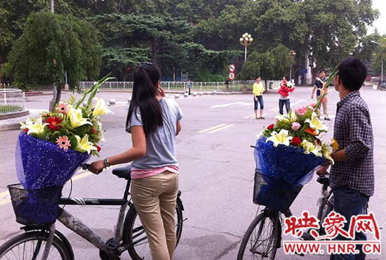 在鄭州大學(xué)南校區(qū)，有不少學(xué)生三五成群，手捧鮮花。