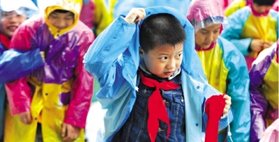 昨日下午,農(nóng)科路上一小學(xué)放學(xué)時,孩子們大部分都穿著雨披。