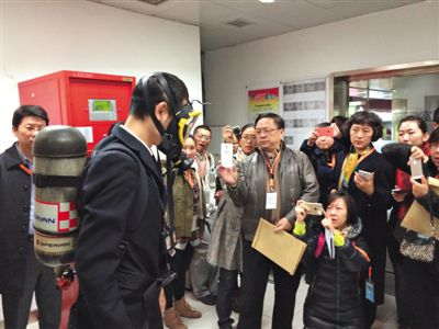 昨天，地鐵4號線北京南站站，地鐵工作人員為人大代表演示應(yīng)急氧氣瓶佩戴方式。新京報記者
