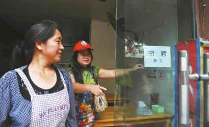 8月14日，市民志愿者體驗城管執(zhí)法招呼商家不要亂張貼。