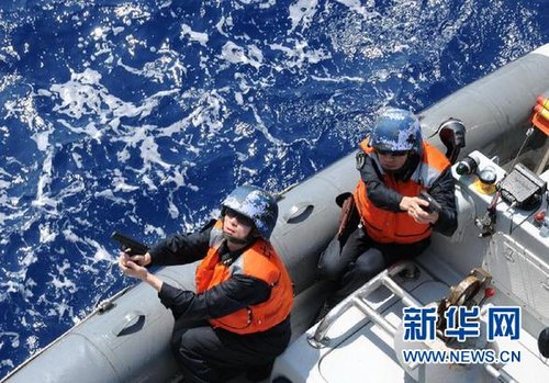 　3月28日，十余名臨檢拿捕隊員乘小艇駛至模擬可疑商船下方水面。
